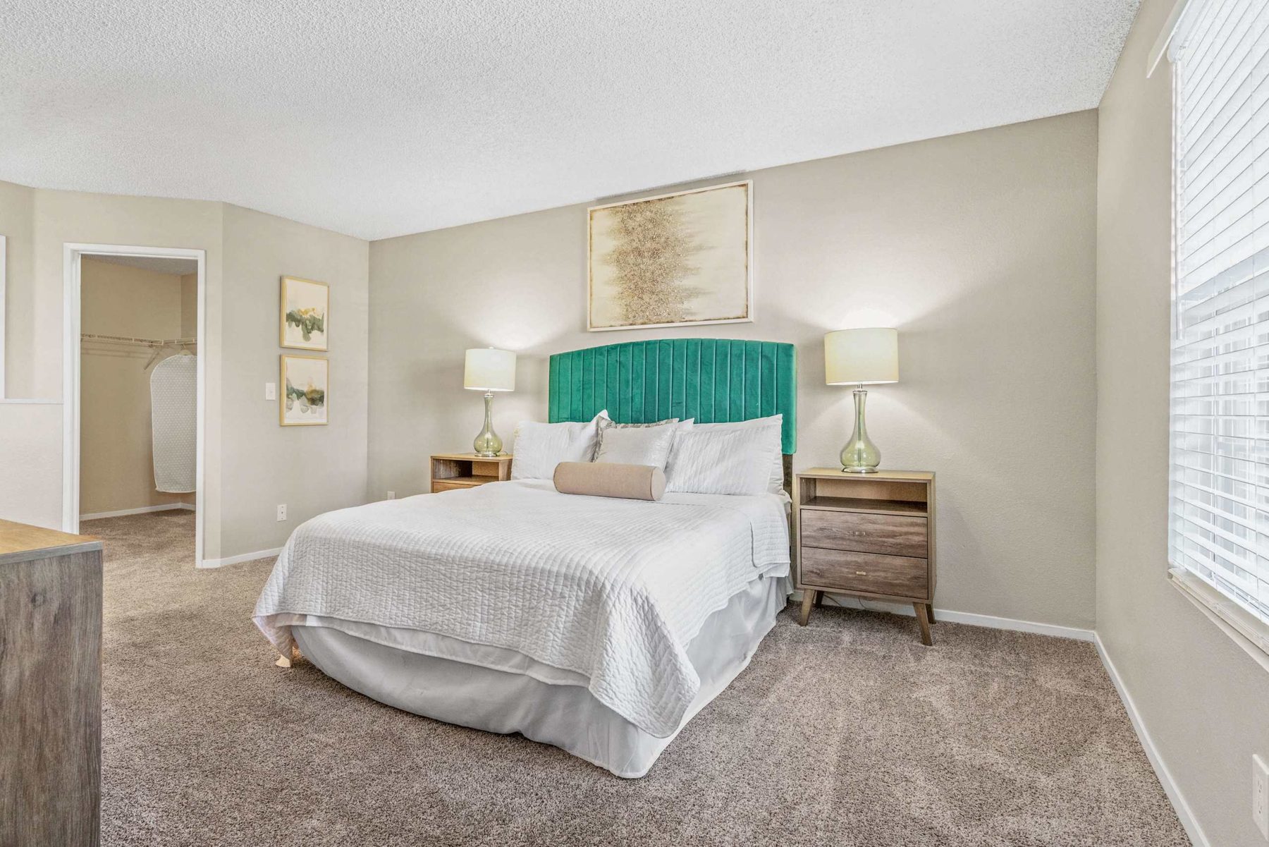 Bedroom with teal upholstered headboard