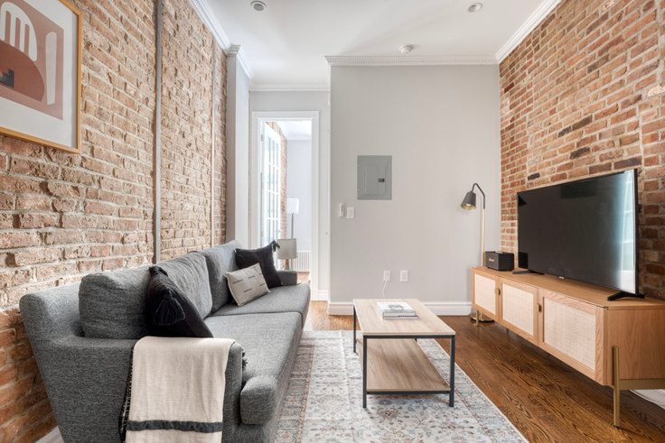 Brickhouse Flat living room with exposed brick wall