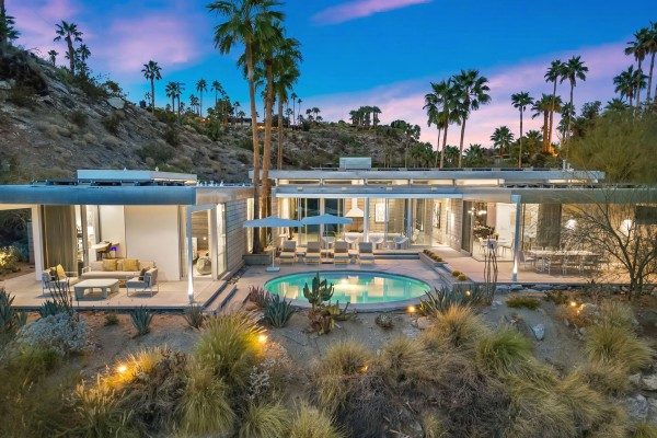 Glass Haus Retreat modern home with private pool at dusk
