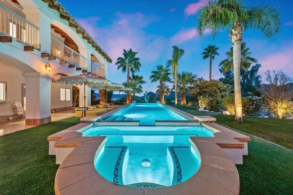 Canyon Villa with lit pool and palm trees